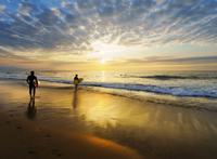 旁边海边冲浪的人们图片